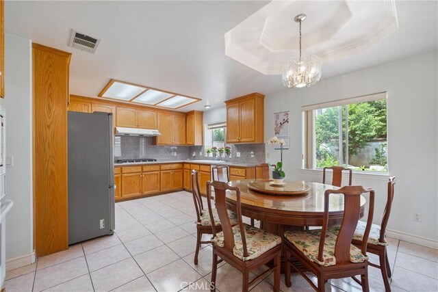 5939 N Vista St, San Gabriel, CA 91775 - dining room with light tile patterned floors, a chandelier, and a tray ceiling