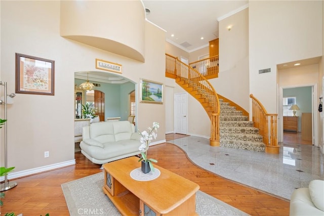 5939 N Vista St, San Gabriel, CA 91775 - living area featuring ornamental molding, arched walkways, wood finished floors, a high ceiling, and stairway