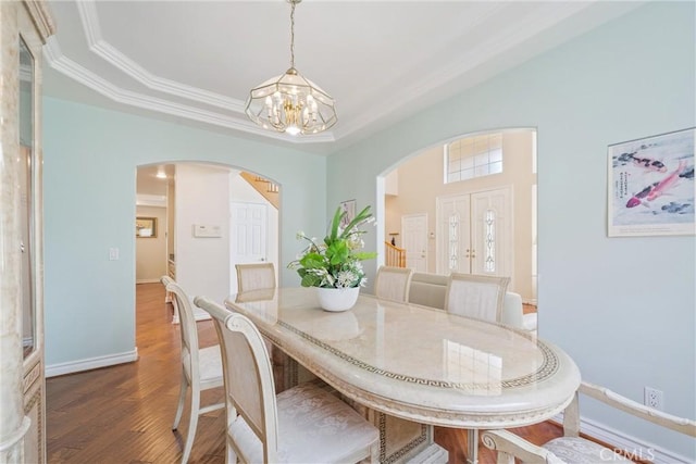 5939 N Vista St, San Gabriel, CA 91775 - dining space with arched walkways, a chandelier, wood finished floors, and crown molding