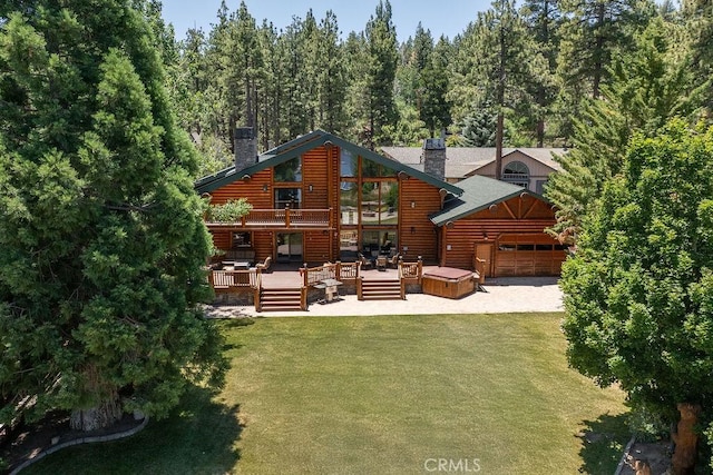 535 Cienega Rd, Big Bear Lake, CA 92315 - back of house with a chimney, a deck, a lawn, and an attached garage
