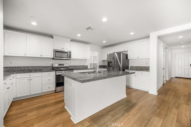 29045 Silver Stirrup Way, Winchester, CA 92596 - kitchen with stainless steel appliances, white cabinetry, light wood-type flooring, and recessed lighting