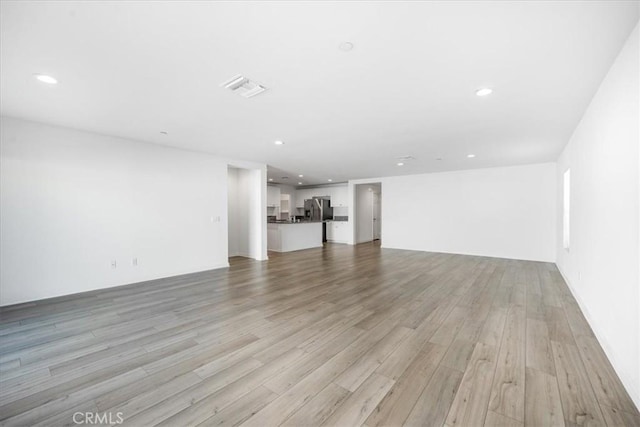 29045 Silver Stirrup Way, Winchester, CA 92596 - unfurnished living room with light wood finished floors and recessed lighting