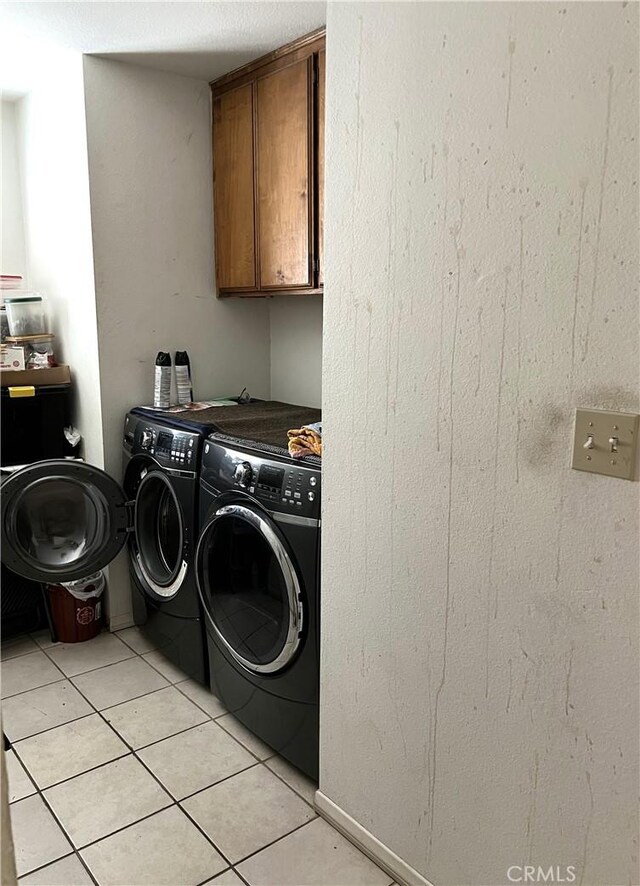 1061 N Perris Blvd, Perris, CA 92571 - laundry area featuring separate washer and dryer, cabinet space, and light tile patterned floors
