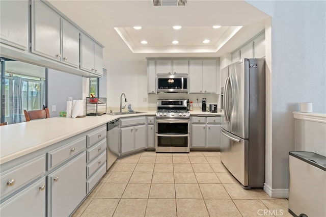 2837 Don Goodwin Dr, Riverside, CA 92507 - kitchen with appliances with stainless steel finishes, a tray ceiling, light tile patterned flooring, recessed lighting, and light countertops
