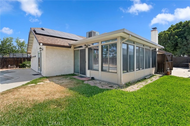 2837 Don Goodwin Dr, Riverside, CA 92507 - back of house with a sunroom, solar panels, stucco siding, and a chimney