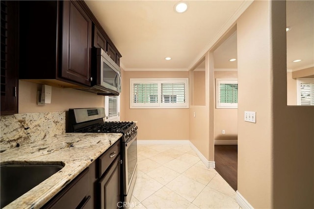 4425 Ashworth St, Lakewood, CA 90712 - kitchen with stainless steel appliances, crown molding, light stone countertops, dark brown cabinetry, and recessed lighting