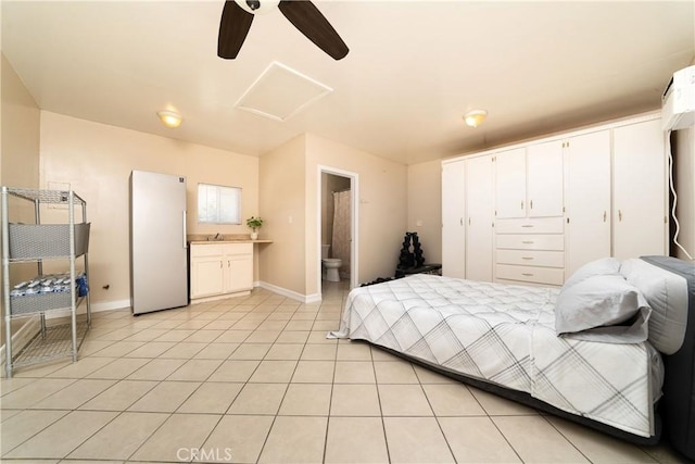 4425 Ashworth St, Lakewood, CA 90712 - bedroom with freestanding refrigerator, attic access, light tile patterned flooring, ensuite bath, and ceiling fan