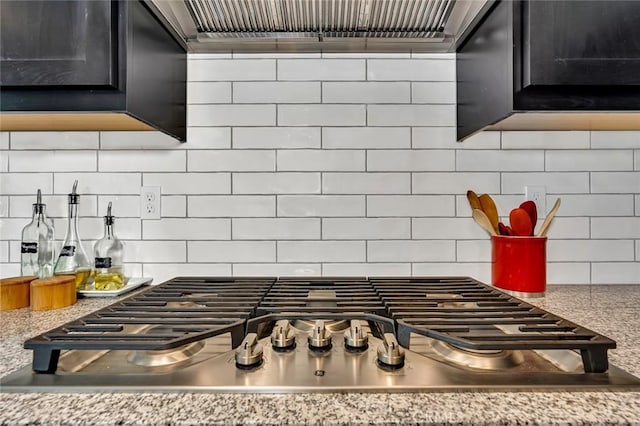 253 Peters Ln S, Madera, CA 93636 - kitchen view of stainless steel gas stovetop, tasteful backsplash, exhaust hood, and dark cabinets