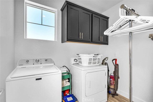 253 Peters Ln S, Madera, CA 93636 - washroom featuring separate washer and dryer, cabinet space, and light wood-style flooring