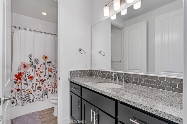253 Peters Ln S, Madera, CA 93636 - bathroom featuring vanity, backsplash, and wood finished floors
