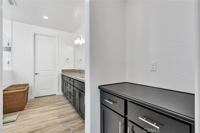 253 Peters Ln S, Madera, CA 93636 - full bath featuring double vanity, wood finished floors, a textured wall, and recessed lighting