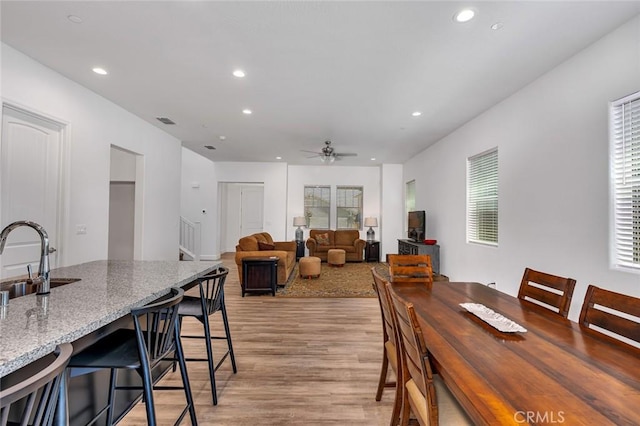 253 Peters Ln S, Madera, CA 93636 - dining area with light wood-style floors, recessed lighting, ceiling fan, and stairway