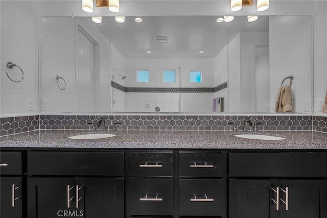 253 Peters Ln S, Madera, CA 93636 - full bathroom with double vanity, tasteful backsplash, and a tile shower