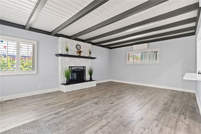 11142 Bertha Pl, Cerritos, CA 90703 - unfurnished living room with a wall mounted air conditioner, beam ceiling, a fireplace, wood finished floors, and plenty of natural light