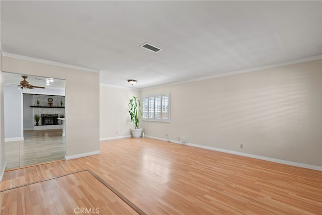 11142 Bertha Pl, Cerritos, CA 90703 - spare room featuring wood finished floors, ceiling fan, a large fireplace, and ornamental molding