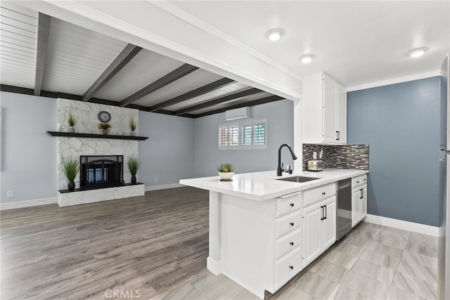 11142 Bertha Pl, Cerritos, CA 90703 - kitchen with dishwasher, a peninsula, light countertops, white cabinetry, and beamed ceiling