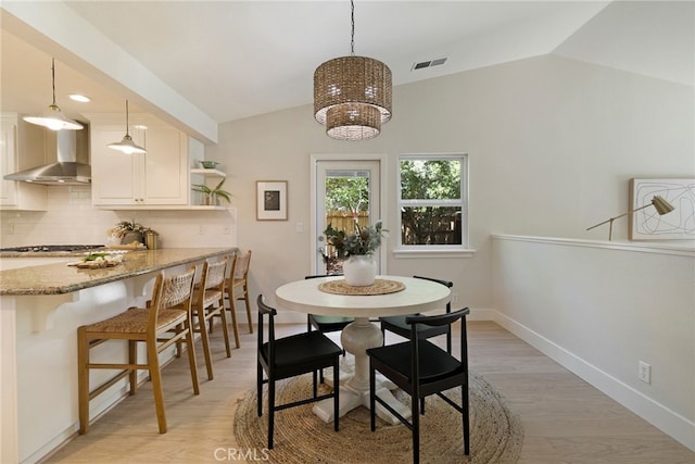 812 Collindale Ct, Chico, CA 95926 - dining area with lofted ceiling, light wood-style floors, and a chandelier