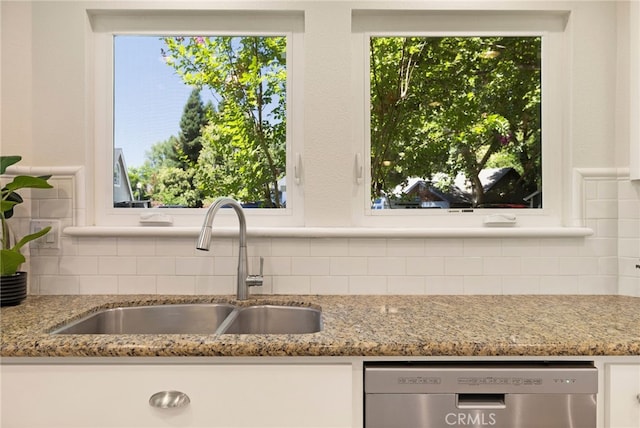 812 Collindale Ct, Chico, CA 95926 - kitchen featuring stainless steel dishwasher, decorative backsplash, white cabinets, and healthy amount of natural light