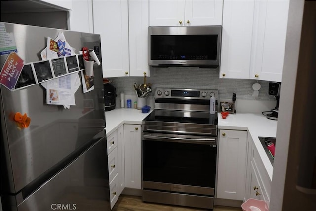 21301 Norwalk Blvd Unit 93, Hawaiian Gardens, CA 90716 - kitchen with appliances with stainless steel finishes, tasteful backsplash, white cabinets, and light countertops