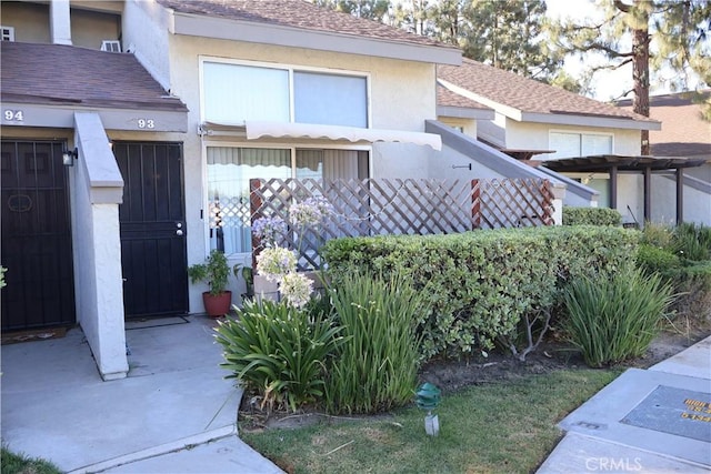 21301 Norwalk Blvd Unit 93, Hawaiian Gardens, CA 90716 - view of front facade featuring stucco siding and a shingled roof
