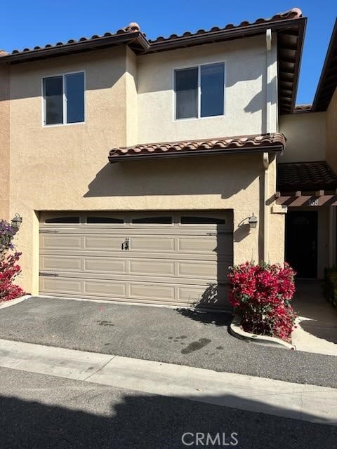 368 Avenida De Amigos, Nipomo, CA 93444 - view of front of home featuring an attached garage, a tiled roof, and stucco siding