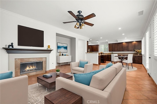 1737 Partridge Ave, Upland, CA 91784 - living room with ornamental molding, recessed lighting, a ceiling fan, light tile patterned floors, and a tile fireplace