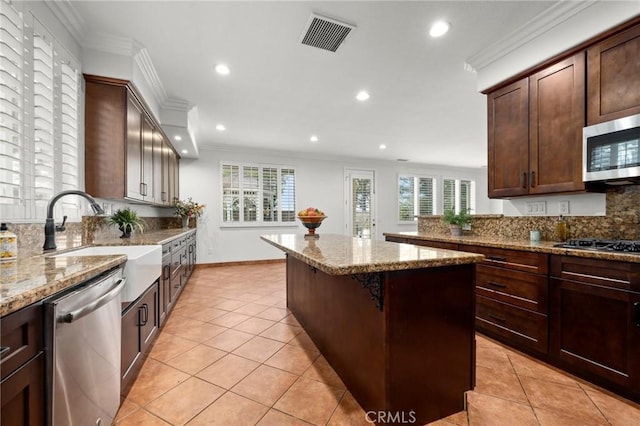 1737 Partridge Ave, Upland, CA 91784 - kitchen featuring stainless steel appliances, a kitchen island, recessed lighting, backsplash, and light stone countertops