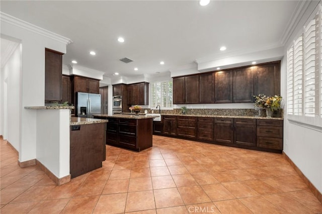 1737 Partridge Ave, Upland, CA 91784 - kitchen featuring appliances with stainless steel finishes, dark brown cabinets, light tile patterned floors, light stone countertops, and decorative backsplash