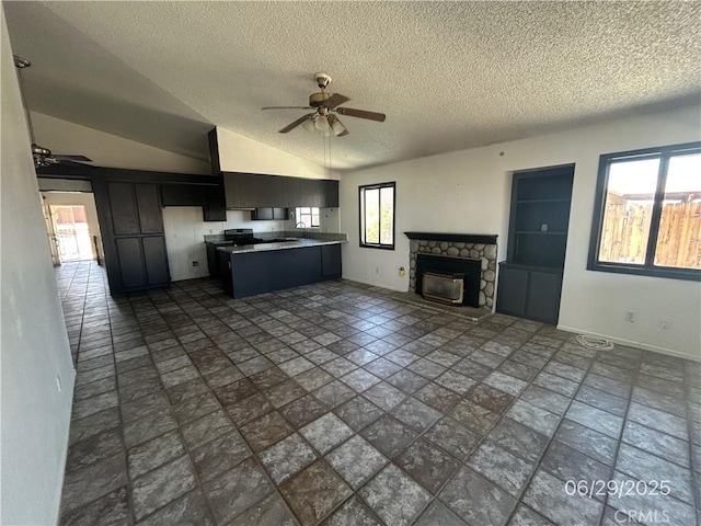 467 Stanford Dr, Barstow, CA 92311 - kitchen with ceiling fan, open floor plan, plenty of natural light, a textured ceiling, and dark cabinets