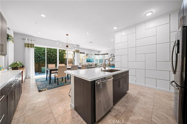 814 Beacon, Irvine, CA 92618 - kitchen with appliances with stainless steel finishes, light countertops, plenty of natural light, a kitchen island with sink, and recessed lighting