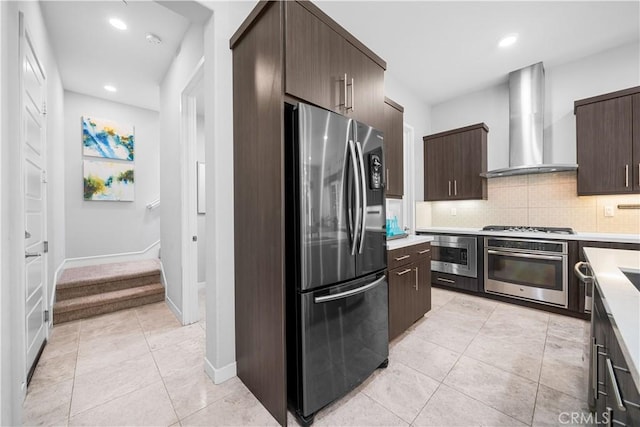 814 Beacon, Irvine, CA 92618 - kitchen with stainless steel appliances, wall chimney range hood, dark brown cabinets, light countertops, and decorative backsplash