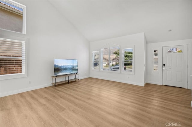 5731 Applecross Dr, Riverside, CA 92507 - unfurnished living room with high vaulted ceiling and light wood-style floors