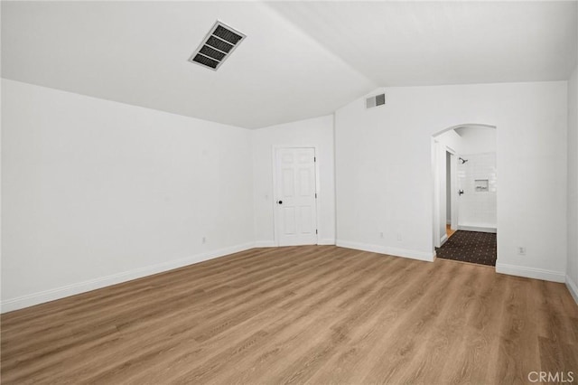 5731 Applecross Dr, Riverside, CA 92507 - unfurnished room with arched walkways, light wood-style flooring, and lofted ceiling