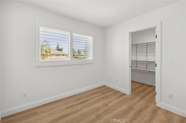 5731 Applecross Dr, Riverside, CA 92507 - unfurnished bedroom with light wood-type flooring, a walk in closet, and a closet