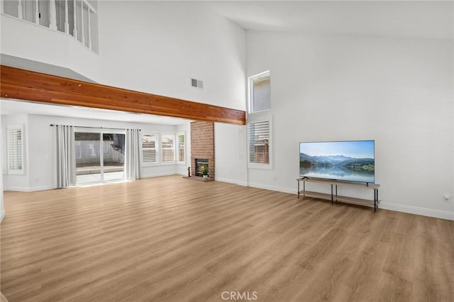 5731 Applecross Dr, Riverside, CA 92507 - unfurnished living room featuring high vaulted ceiling, light wood-style floors, and a brick fireplace