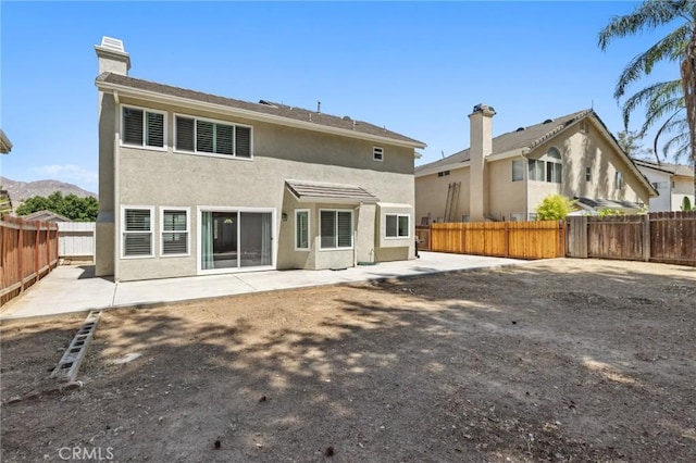 5731 Applecross Dr, Riverside, CA 92507 - back of property featuring a patio, stucco siding, and a fenced backyard