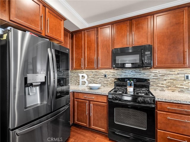 18387 Evening Primrose Ln, San Bernardino, CA 92407 - kitchen with black appliances, ornamental molding, light stone countertops, backsplash, and wood finished floors