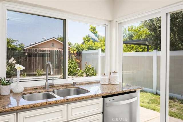 22811 Fortuna Ln, Mission Viejo, CA 92691 - kitchen with dishwasher, light stone countertops, and white cabinetry
