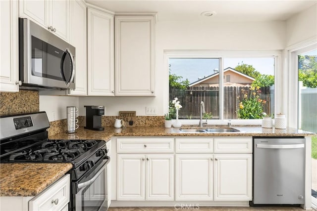 22811 Fortuna Ln, Mission Viejo, CA 92691 - kitchen with stainless steel appliances, white cabinetry, and light stone countertops