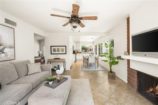 22811 Fortuna Ln, Mission Viejo, CA 92691 - living area featuring a brick fireplace, light tile patterned flooring, and ceiling fan
