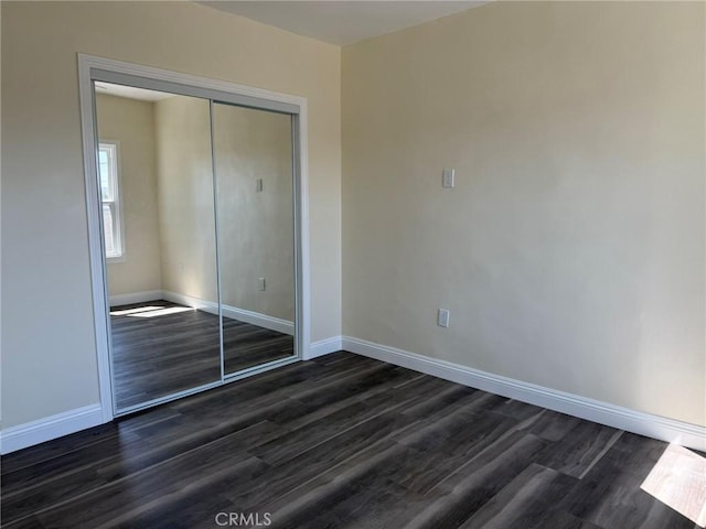 817 Orange Grove Ave, Colton, CA 92324 - unfurnished bedroom featuring dark wood-style flooring and a closet