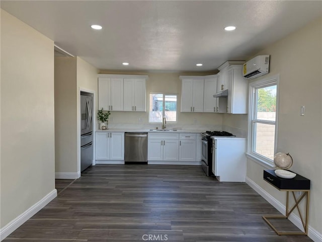 817 Orange Grove Ave, Colton, CA 92324 - kitchen with appliances with stainless steel finishes, a wall unit AC, white cabinetry, and recessed lighting