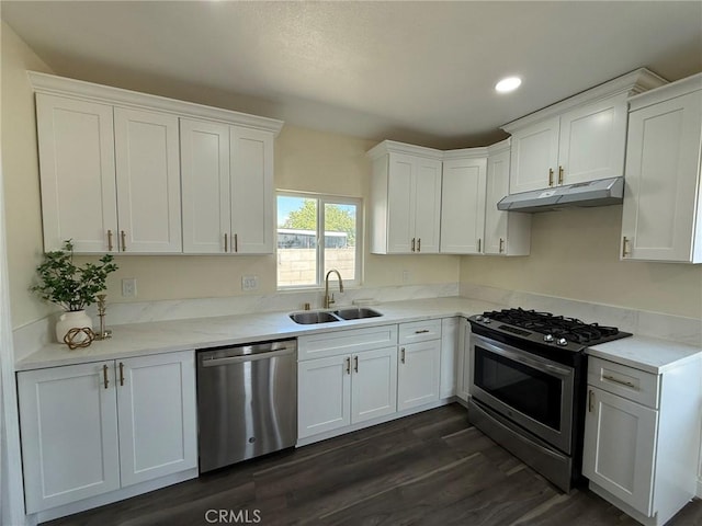 817 Orange Grove Ave, Colton, CA 92324 - kitchen with appliances with stainless steel finishes, under cabinet range hood, white cabinets, dark wood-type flooring, and recessed lighting