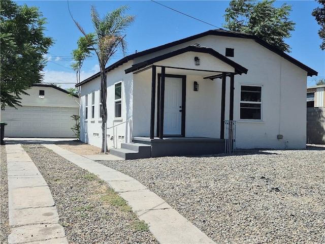 817 Orange Grove Ave, Colton, CA 92324 - view of front facade with stucco siding, an outdoor structure, and a garage