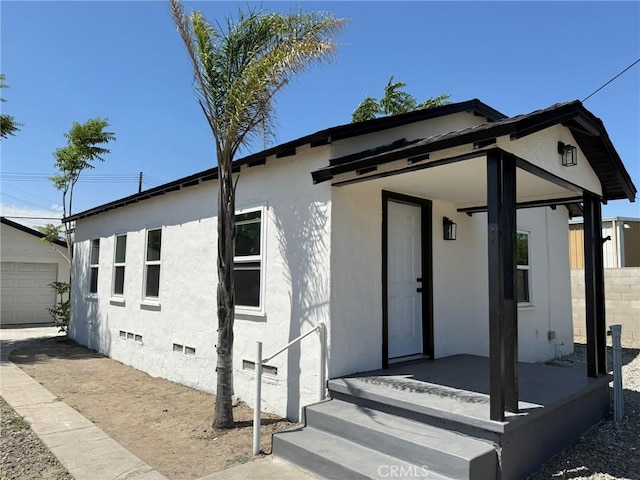 817 Orange Grove Ave, Colton, CA 92324 - view of front of house featuring crawl space, stucco siding, an outdoor structure, and a garage