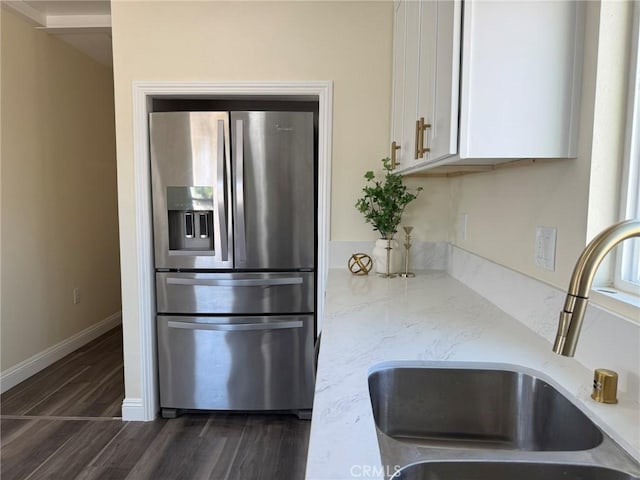 817 Orange Grove Ave, Colton, CA 92324 - kitchen featuring stainless steel fridge, white cabinets, dark wood-style flooring, and light stone counters