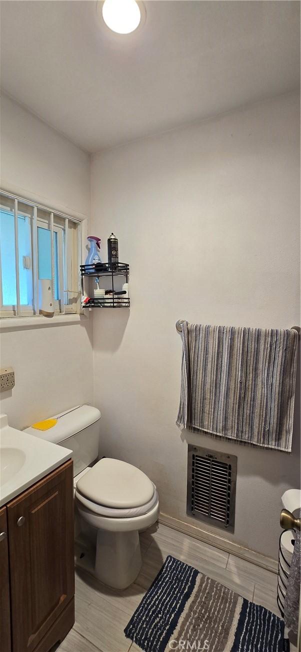 6718 Del Rosa Dr, San Bernardino, CA 92404 - half bath with vanity and wood finished floors