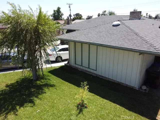6718 Del Rosa Dr, San Bernardino, CA 92404 - view of side of home featuring roof with shingles and a lawn