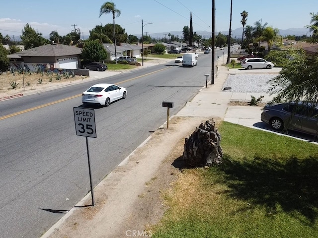 6718 Del Rosa Dr, San Bernardino, CA 92404 - view of asphalt street with a residential view and street lighting