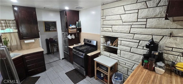 6718 Del Rosa Dr, San Bernardino, CA 92404 - kitchen featuring stainless steel appliances, light countertops, decorative backsplash, light tile patterned flooring, and dark brown cabinetry